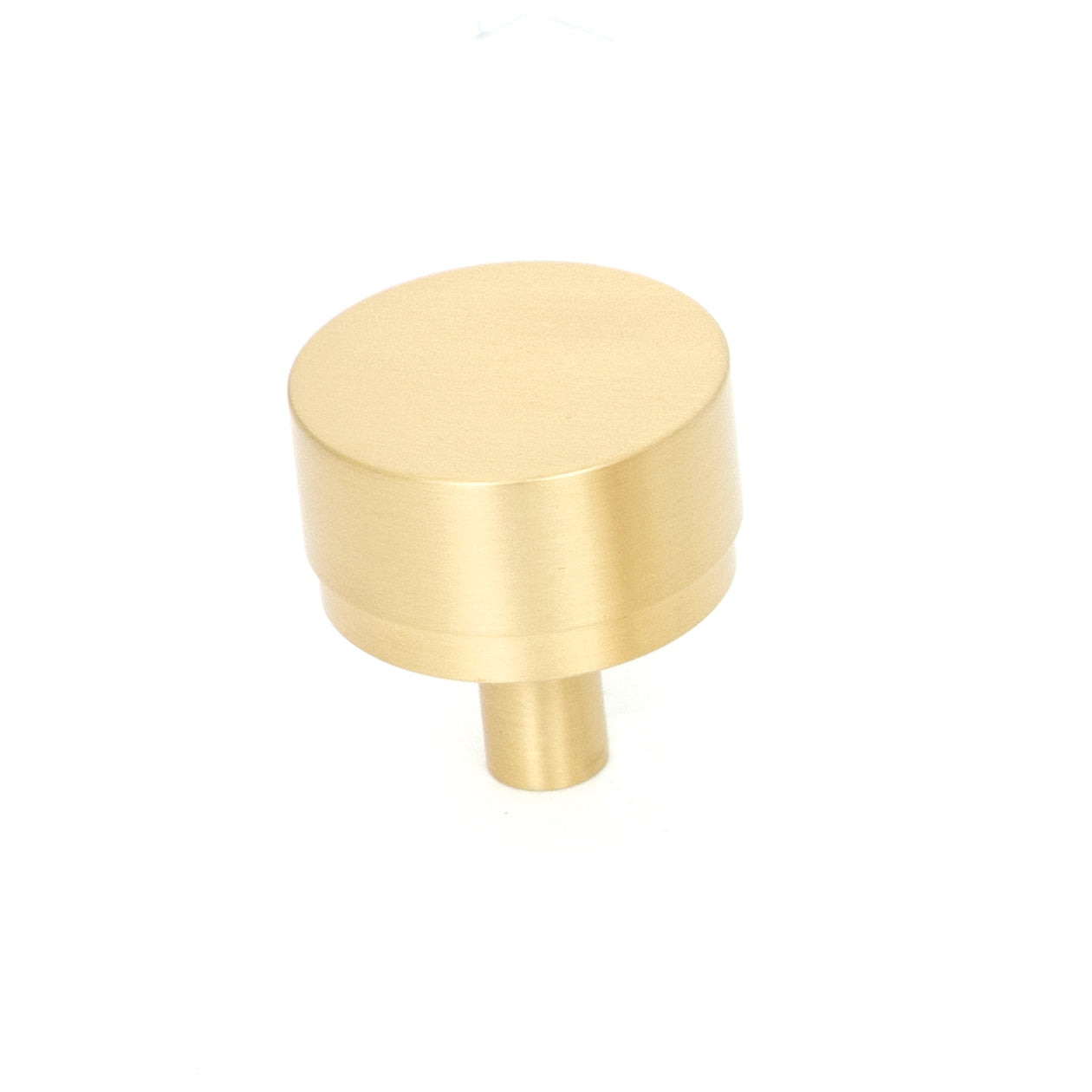 Momo Bellevue plain cabinet knob in black satin finish, showing a sleek round design on a wooden cabinet.