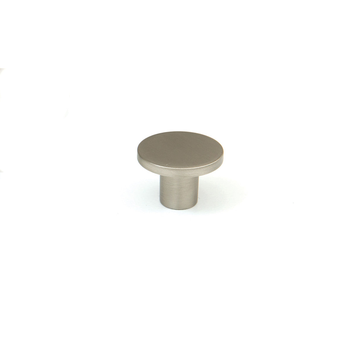 Momo COMO cabinet knob in brown finish with a rounded design, mounted on a wooden cabinet door.