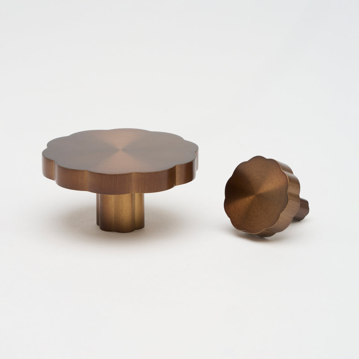 Lo & Co Tropez knob, cabinet hardware in brushed bronze finish, with a rounded, modern design for furniture or cabinetry.