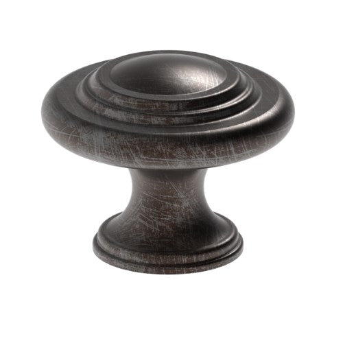 Kethy HT662 Bingley round cabinet knob in antique brass finish on a wooden cabinet door.