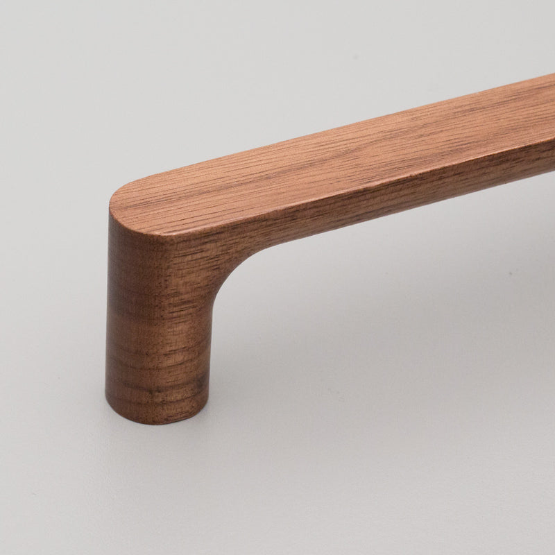 Kethy Timber Pinta timber cabinet pull in warm wood finish, featuring a sleek, modern design for kitchen or bathroom cabinetry.