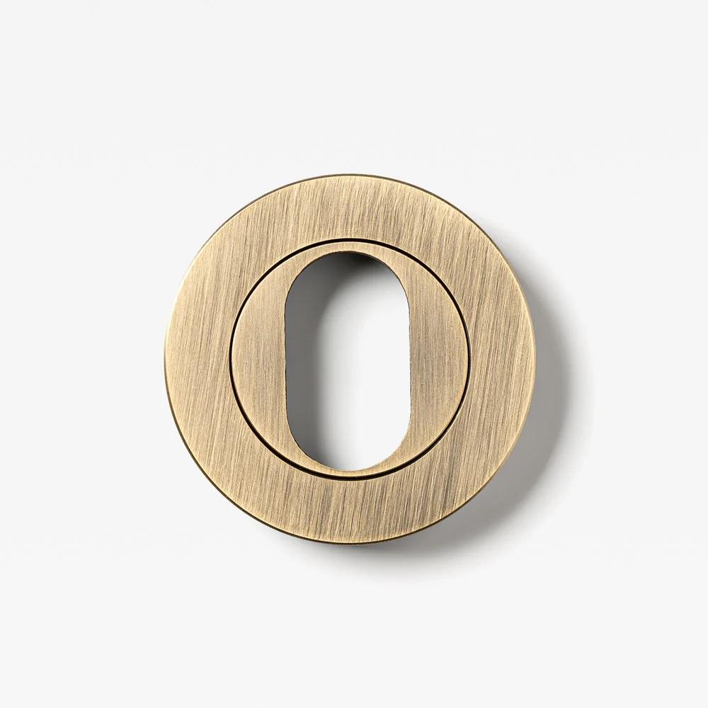 Round oval cylinder escutcheon from Lo & Co Interiors, architectural hardware with a sleek finish and smooth surface.