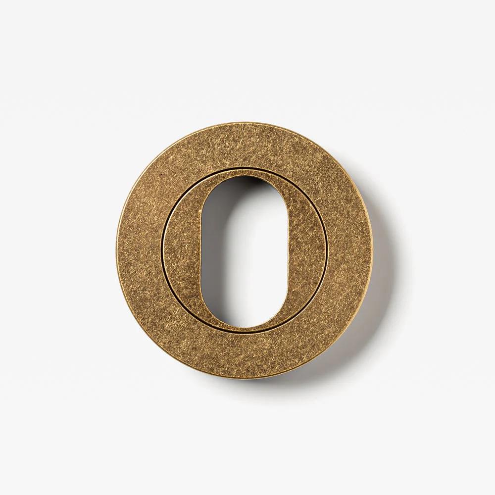 Round oval cylinder escutcheon from Lo & Co Interiors, architectural hardware with a sleek, brushed metal finish.