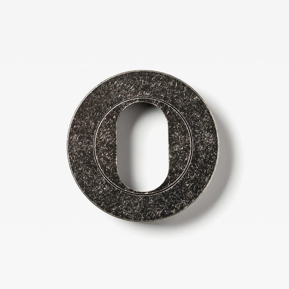 Lo & Co Round Oval Cylinder Escutcheon in bronze finish, architectural hardware with smooth oval design for door or fixture protection.
