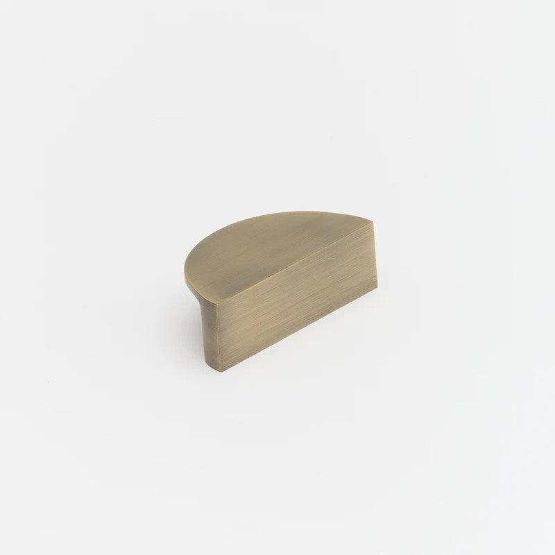 Lo & Co Luna Pull, architectural hardware handle in brushed brass finish, mounted on a sleek modern door.