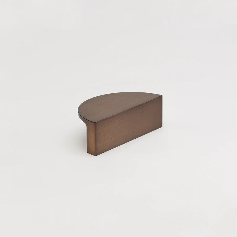 Lo & Co Luna Pull, architectural hardware in brushed bronze finish, featuring sleek modern design for cabinets or furniture.
