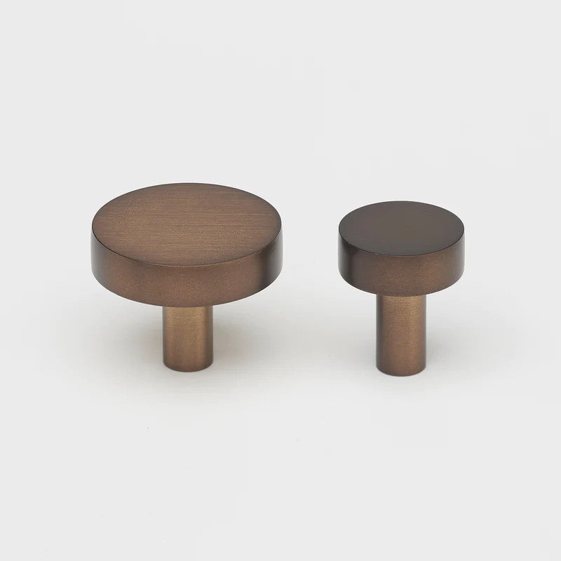 Lo & Co Ascot knob cabinet hardware in brushed bronze, featuring a stylish, rounded design for furniture or cabinetry.