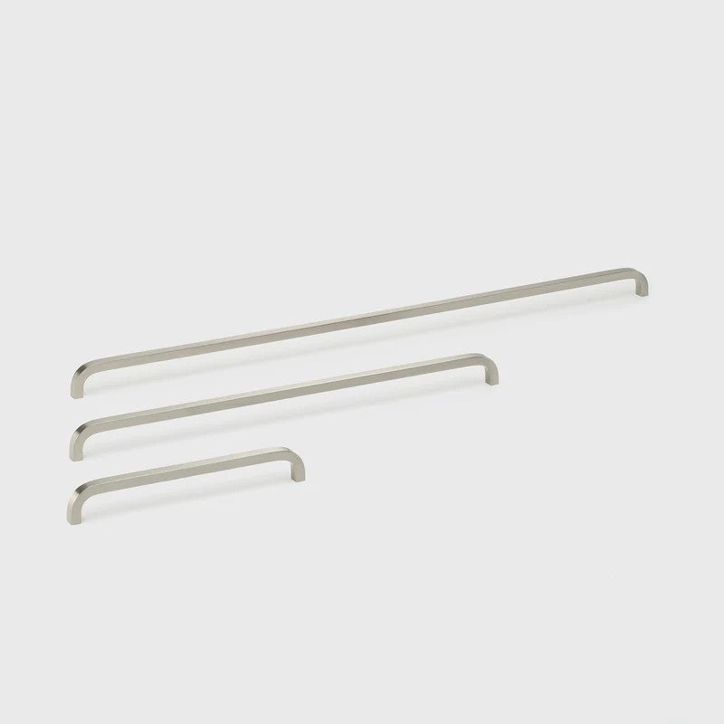 Lo & Co Interiors Curve Pull cabinet hardware in brushed nickel finish, featuring a sleek, curved design for modern kitchen or bathroom cabinets.