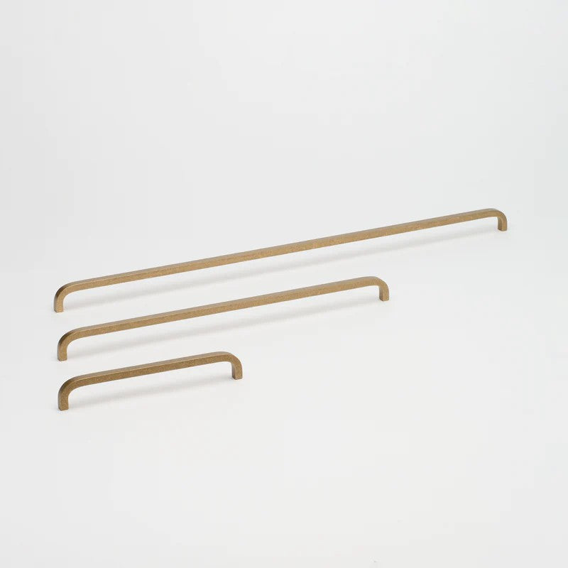 Lo & Co Interiors Curve Pull cabinet hardware in matte black, showcasing sleek curved design and metal finish.