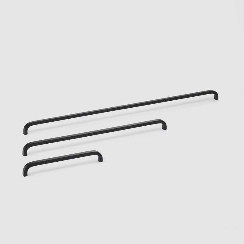 Lo & Co Interiors Curve Pull cabinet hardware, sleek metal handle with a curved design for kitchen or bathroom cabinets.