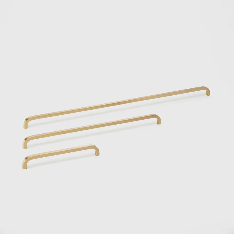 Lo & Co Interiors Curve Pull cabinet hardware in US4 finish, showcasing sleek, curved metal handle for kitchen or furniture drawers.