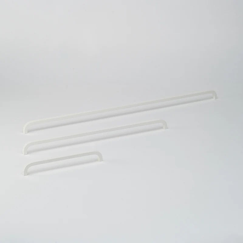 Lo & Co Interiors Curve Pull cabinet hardware in brushed nickel, featuring a sleek, curved design for modern kitchen or bathroom cabinets.