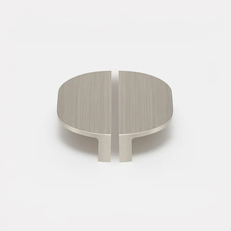 Brushed nickel Lo & Co Isla Pull cabinet hardware mounted on a wooden cabinet door. Modern, sleek design by Lo & Co Interiors.
