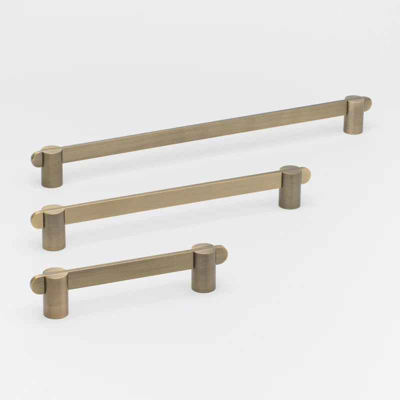 Lo & Co Intersect Pull architectural hardware with sleek, modern design, featuring a polished brass finish.