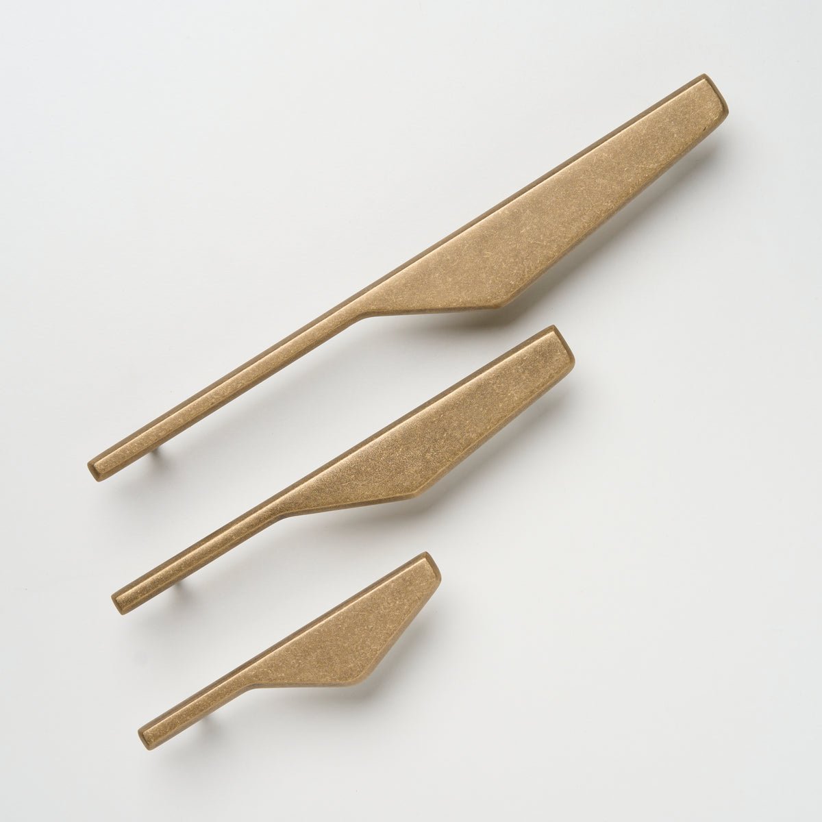 Lo & Co Outline Pull cabinet hardware in right D-shape with brushed bronze finish, mounted on a cabinet door.
