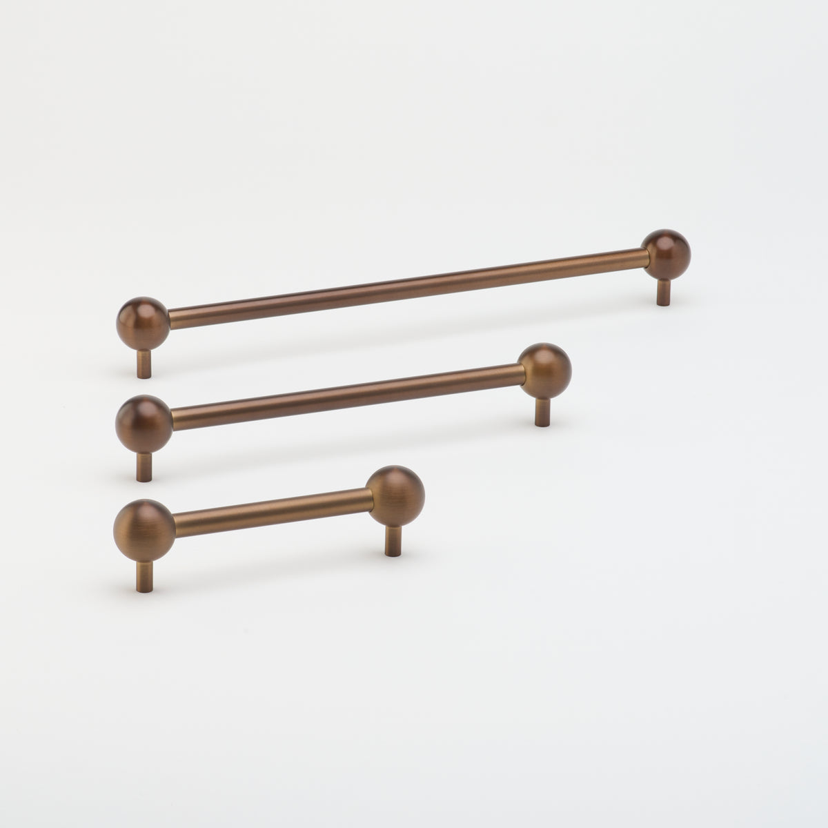 Lo & Co Interiors Sphere Pull cabinet hardware in brushed bronze finish, featuring a spherical handle design for modern kitchen or furniture.