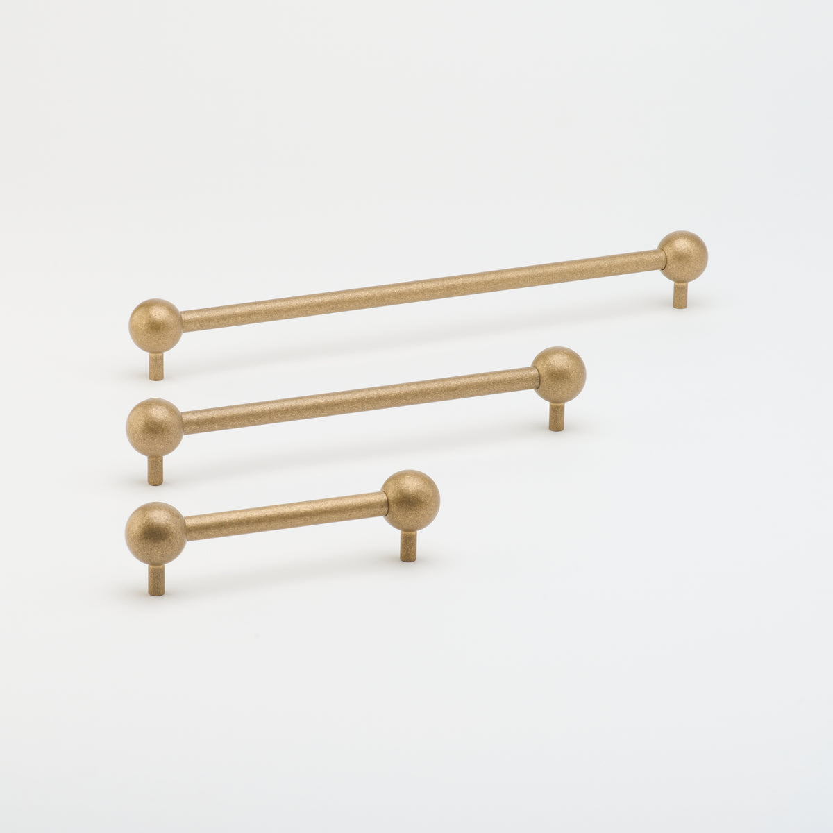 Lo & Co Sphere Pull cabinet hardware in brushed bronze finish, featuring a round, modern design mounted on a cabinet door.