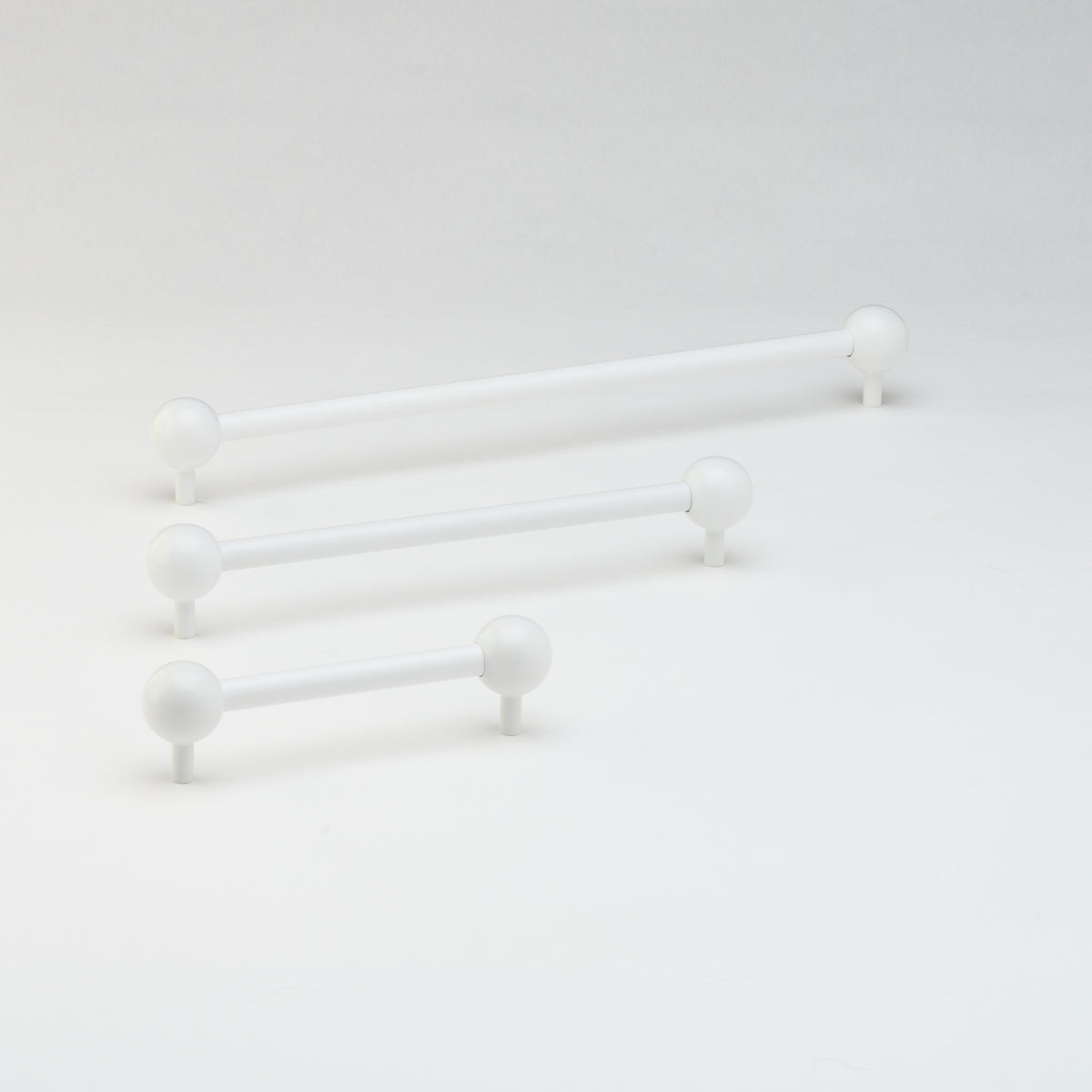 Lo & Co Sphere Pull cabinet hardware with round, polished metal finish mounted on a cabinet door.