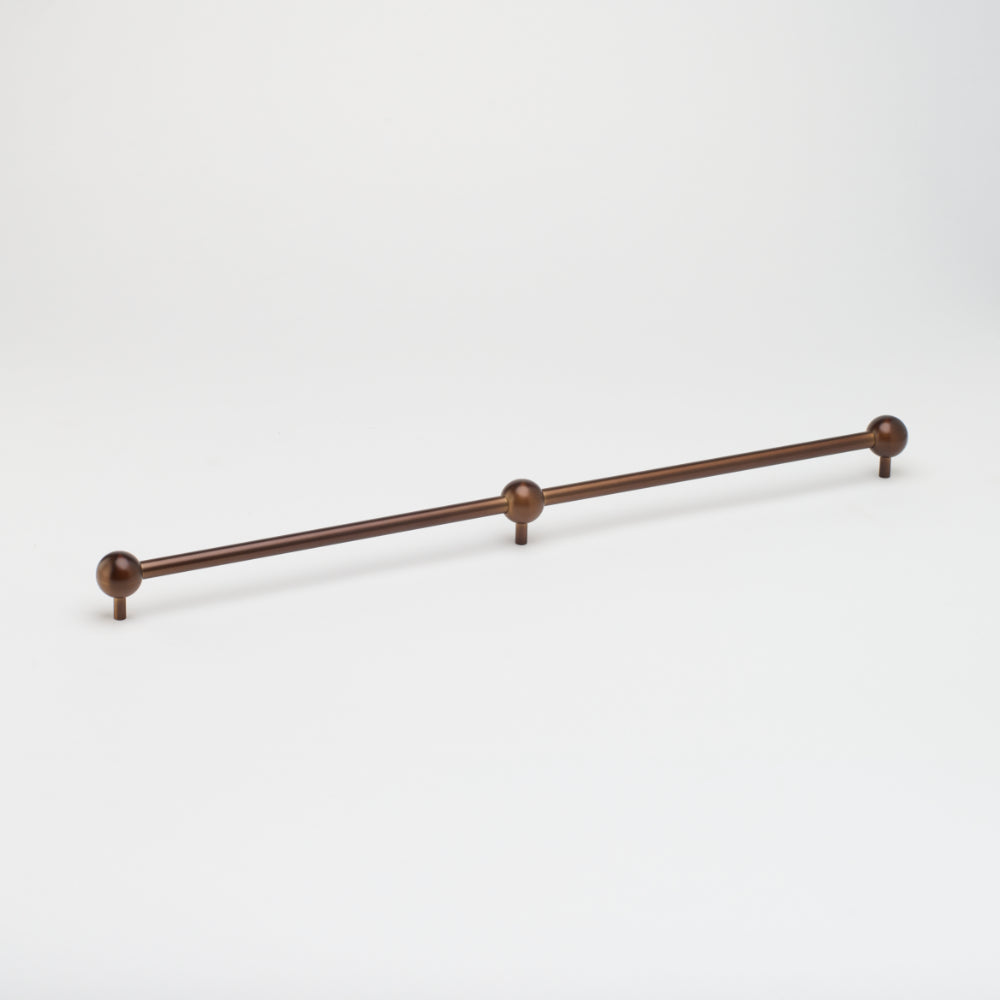 Brass Lo & Co Sphere Appliance Pull, cabinet hardware with round spherical handle for kitchen or furniture drawers.