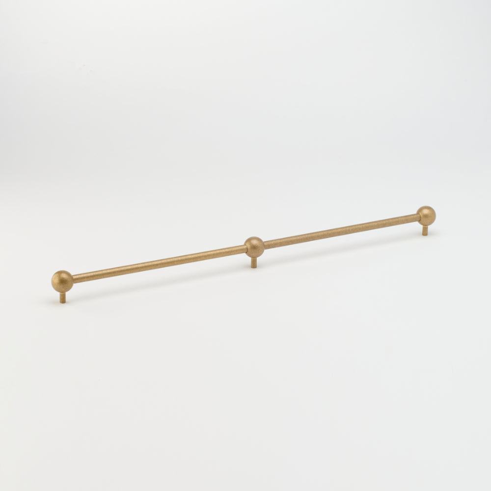 Lo & Co Sphere Appliance Pull cabinet hardware in brushed bronze finish, featuring a sleek round design for kitchen or furniture.