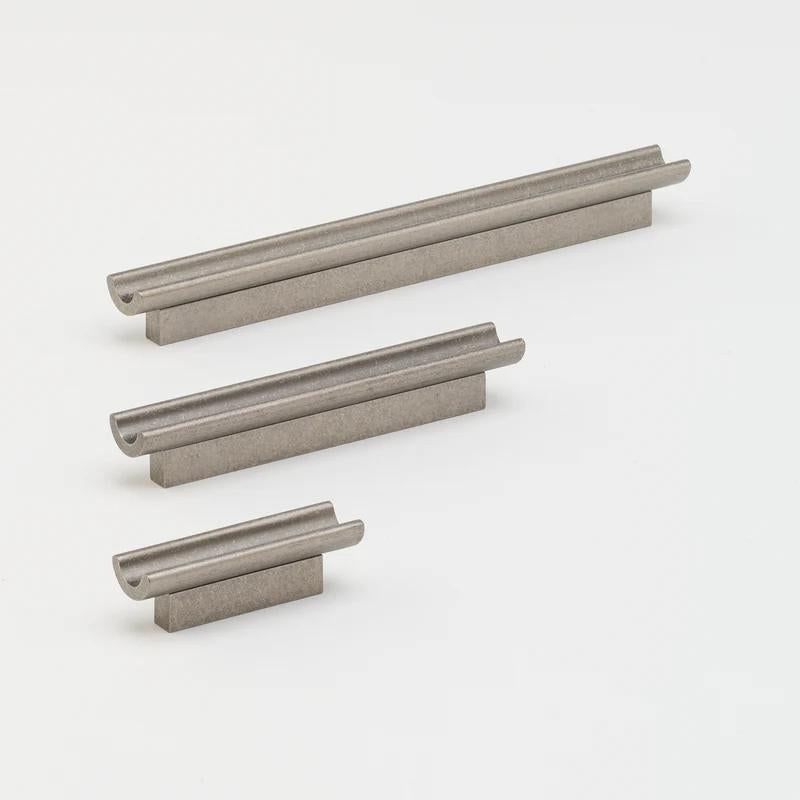 Lo & Co Interiors inline pull cabinet hardware in a sleek metallic finish on a modern cabinet.