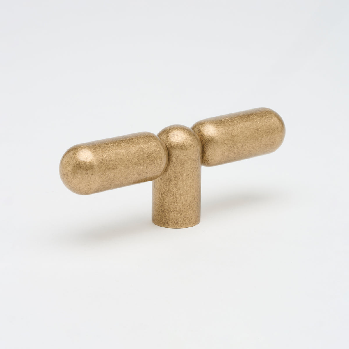 Lo & Co Tubby T-Pull cabinet hardware in a bronze finish with a modern T-shaped design, mounted on a cabinet door.
