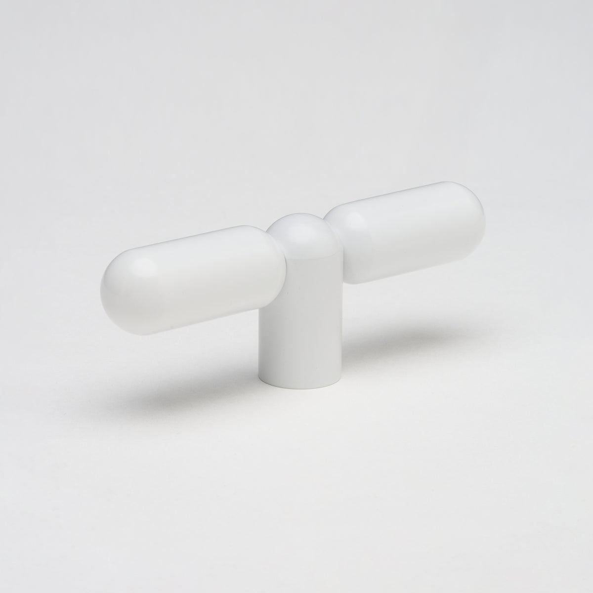 Lo & Co Tubby T-Pull cabinet hardware in brushed nickel finish mounted on a wooden cabinet door