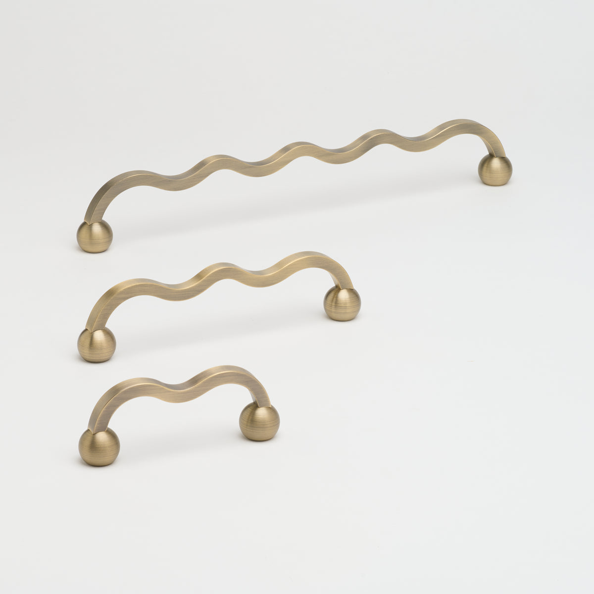Capri Pull cabinet hardware by Lo & Co Interiors, brushed antique bronze finish on sleek drawer handle profile.