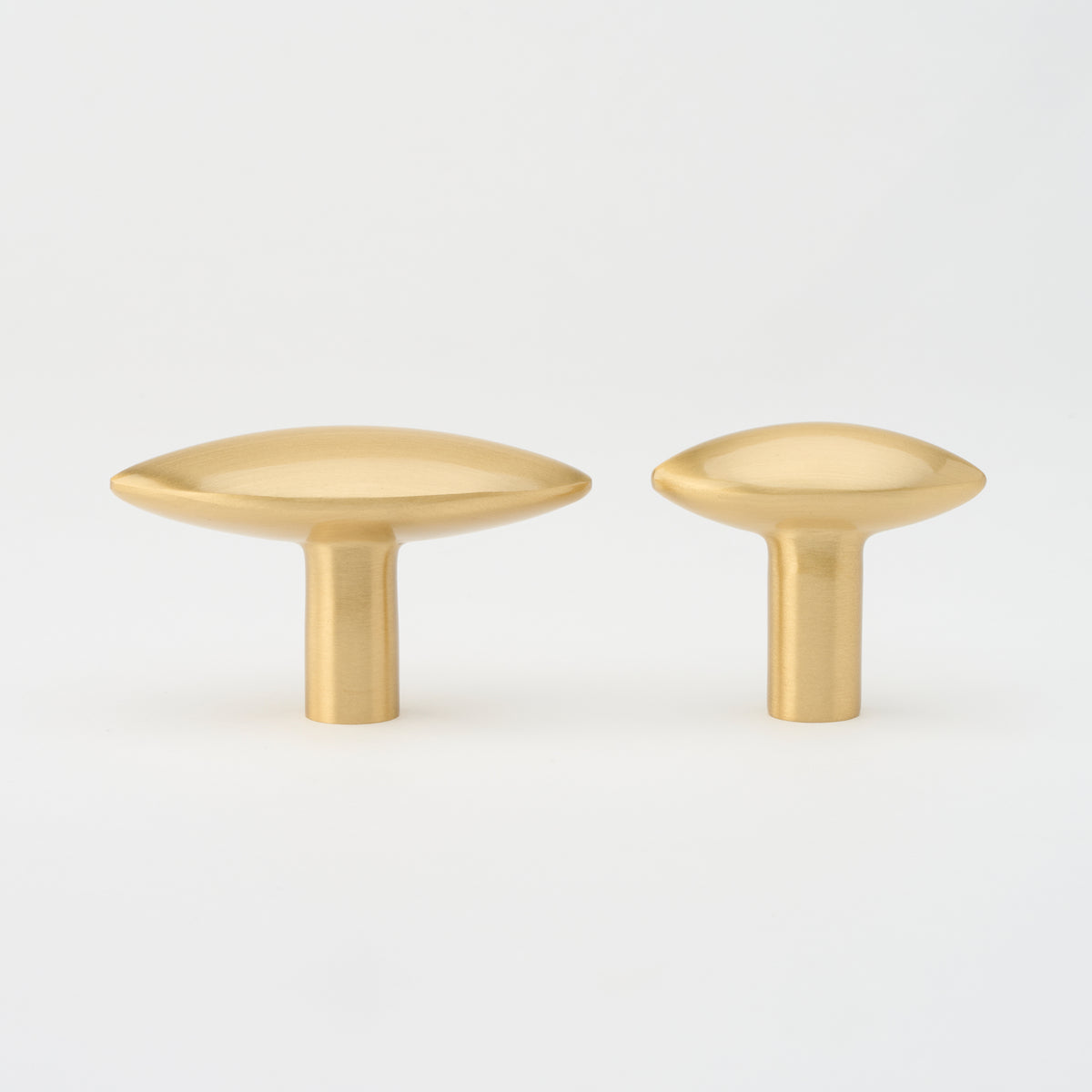 Lo & Co Almond Knob cabinet hardware, beige ceramic with brass base, modern kitchen or furniture accent.
