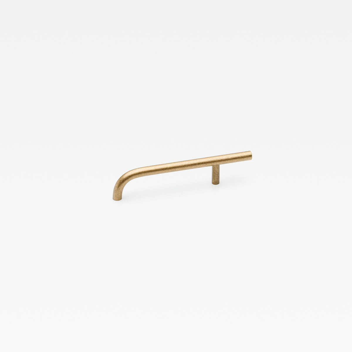 Brera Lo & Co Interiors cabinet pull handle in brushed bronze finish, mounted on a wooden cabinet door.