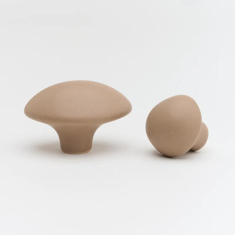 Ceramic pebble cabinet knob in soft gray with smooth rounded shape, ideal for modern furniture hardware by Lo & Co Interiors.