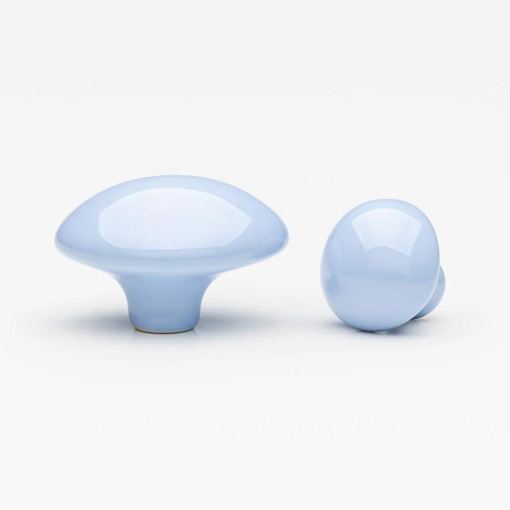 Large blue ceramic pebble cabinet knob by Lo & Co Interiors, showcasing smooth rounded design for furniture hardware.
