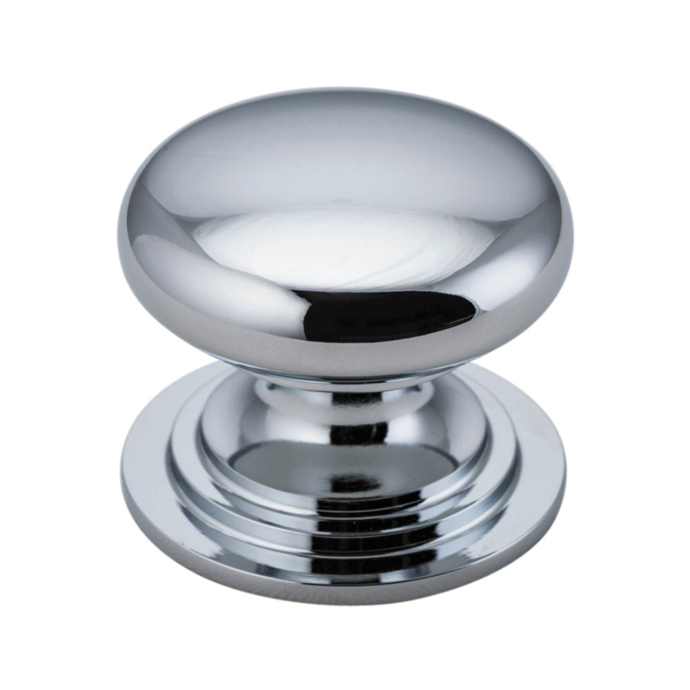 Iver Sarlat cupboard knob from architectural hardware with a classic, rounded metal design on a wooden cabinet.