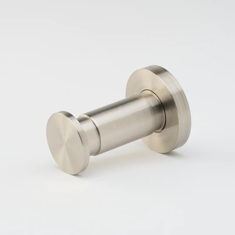 Brushed nickel Lo & Co Lola towel hook mounted on wall, showcasing modern architectural hardware design by Lo & Co Interiors.
