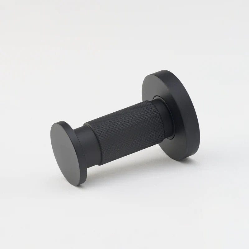 Lo & Co Kintore towel hook mounted on wall, showing sleek architectural hardware design in brushed metal finish.