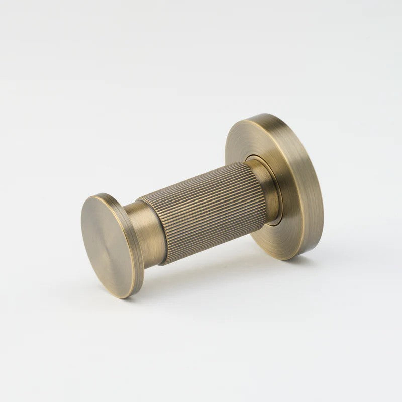 Lo & Co Linear Towel Hook in brushed nickel mounted on a bathroom wall, showcasing modern architectural hardware design.