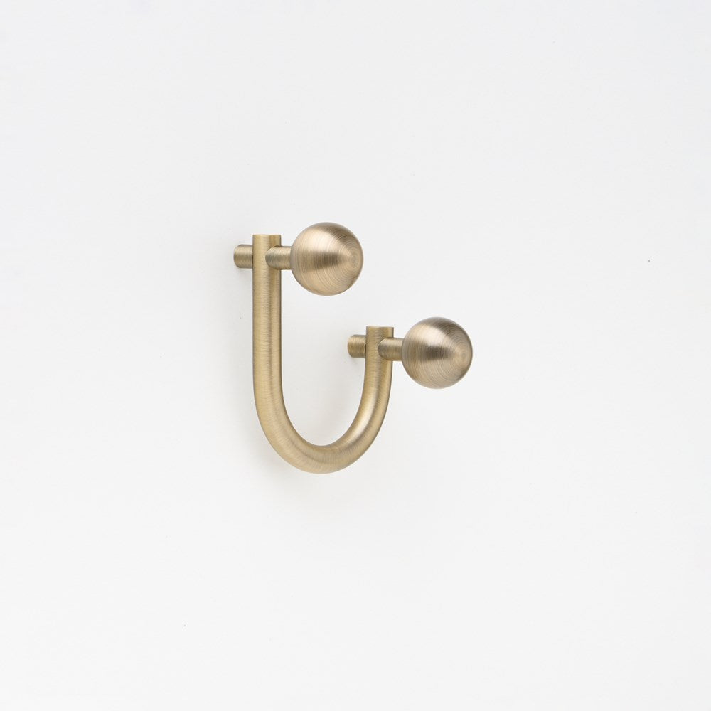 Small Lo & Co Sphere Hook from Lo & Co Interiors, showcasing a sleek architectural hardware design with a spherical shape.