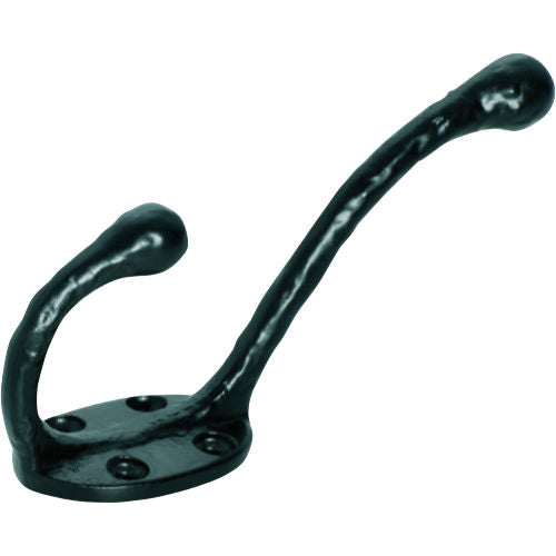 Tradco iron hat and coat hook mounted on wall, vintage-style metal wall hook with curved design for hanging hats and coats.