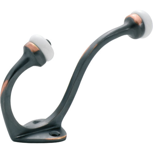 Tradco porcelain tip hat and coat hook mounted on a wall, featuring a classic design with porcelain accents and sturdy metal hooks.