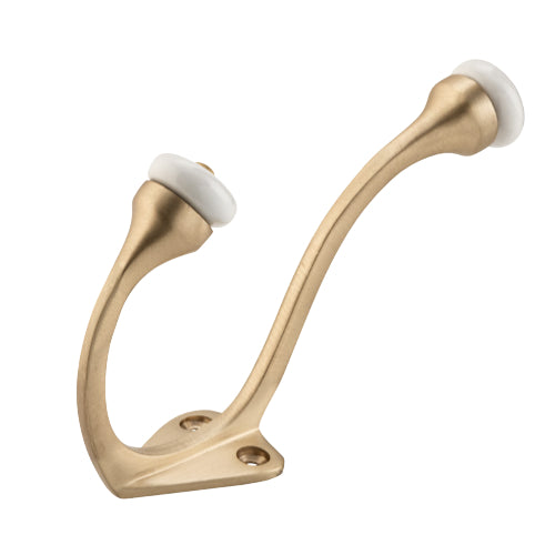 Tradco porcelain tip hat and coat hook mounted on wall, stylish white ceramic design with metal hook for hanging accessories.