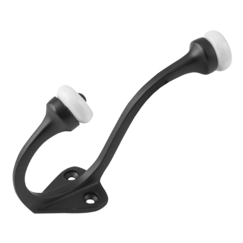 Tradco porcelain tip hat and coat hook mounted on wall, durable ceramic design with metal hook for hanging accessories.
