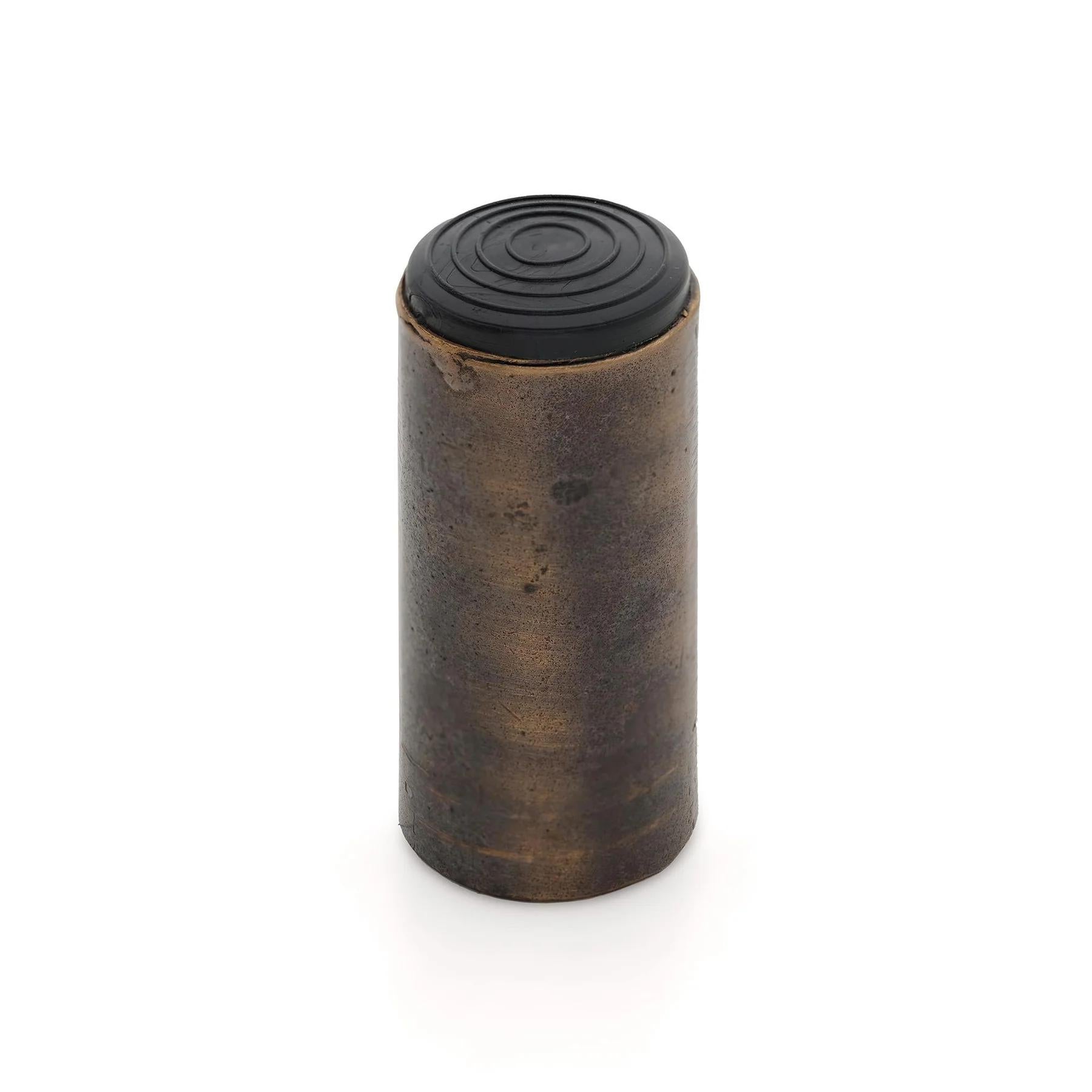 Castella Cast Wall Door Stop mounted on wall, durable metal construction with a sleek design for preventing door damage.