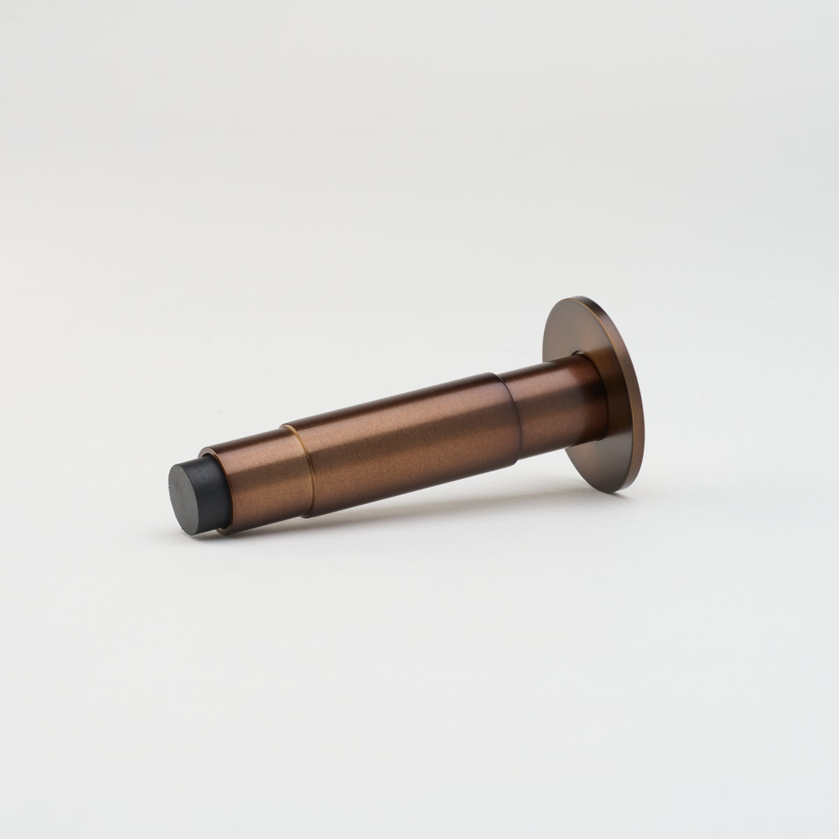 Lo & Co Lola doorstop in bronze, architectural hardware style, featuring a sleek, modern design with a sturdy base.