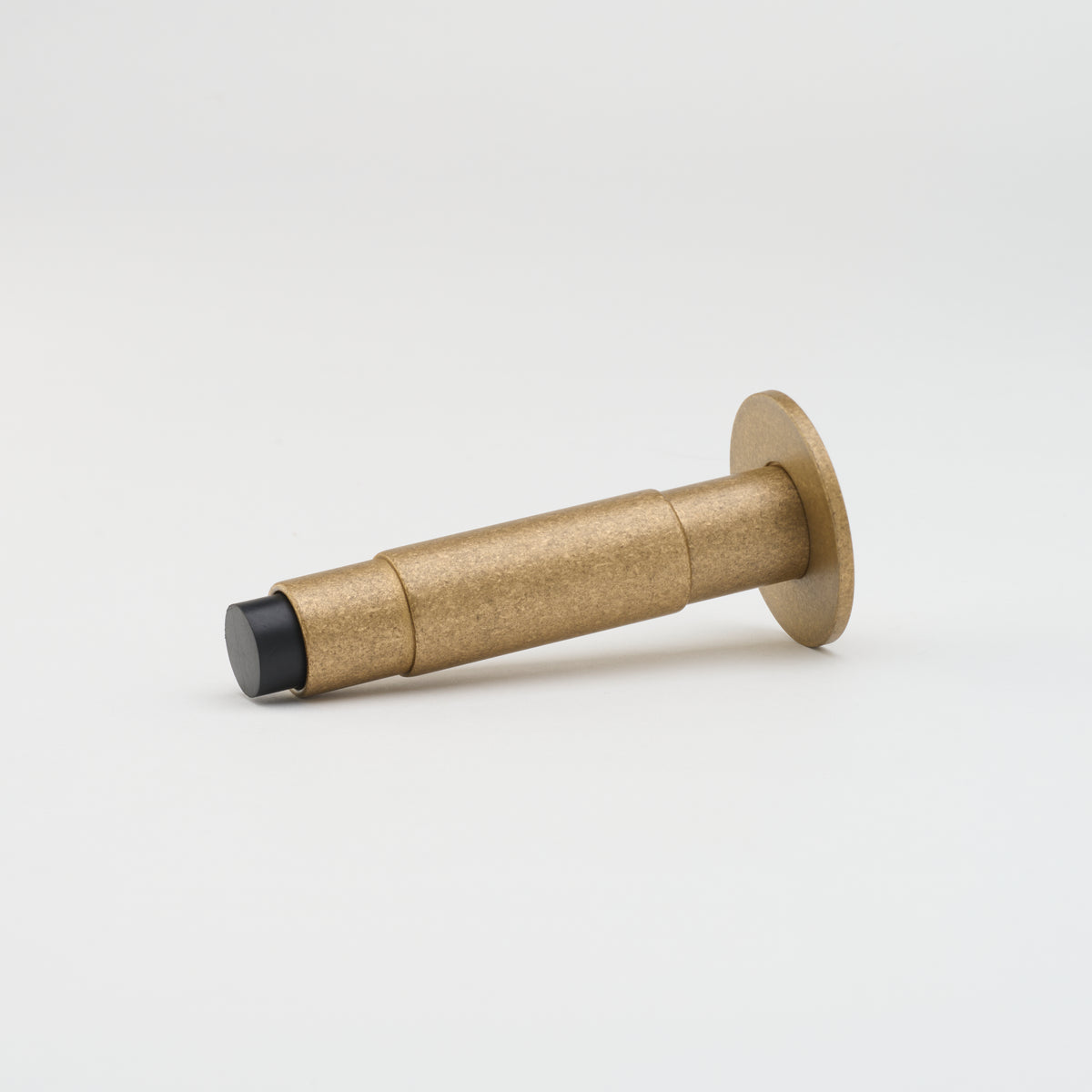 Lo & Co Lola doorstop made of bronze, featuring a sleek architectural hardware design for securing doors.