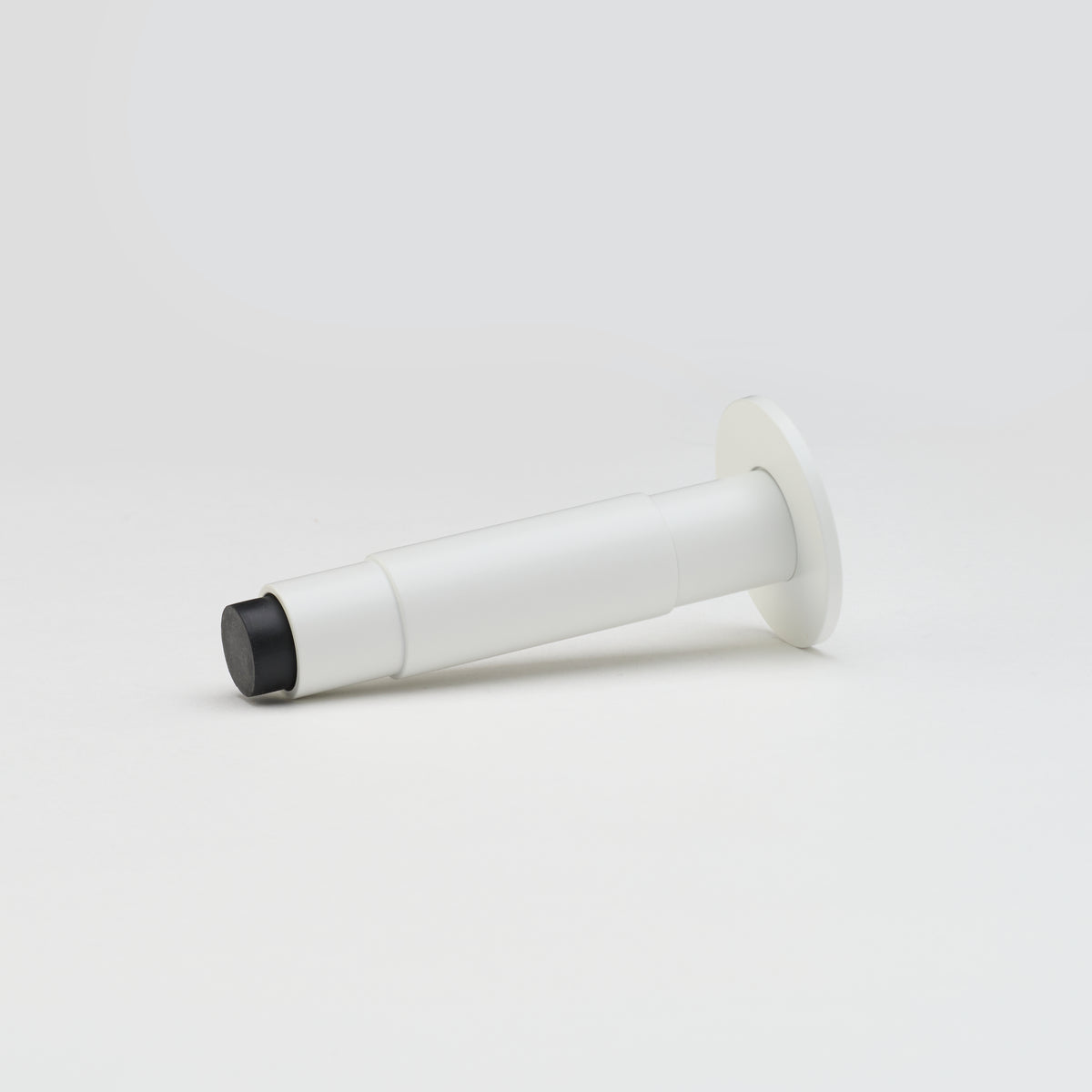 Lo & Co Lola Doorstop in white, decorative architectural hardware with a modern design for door security and stability.