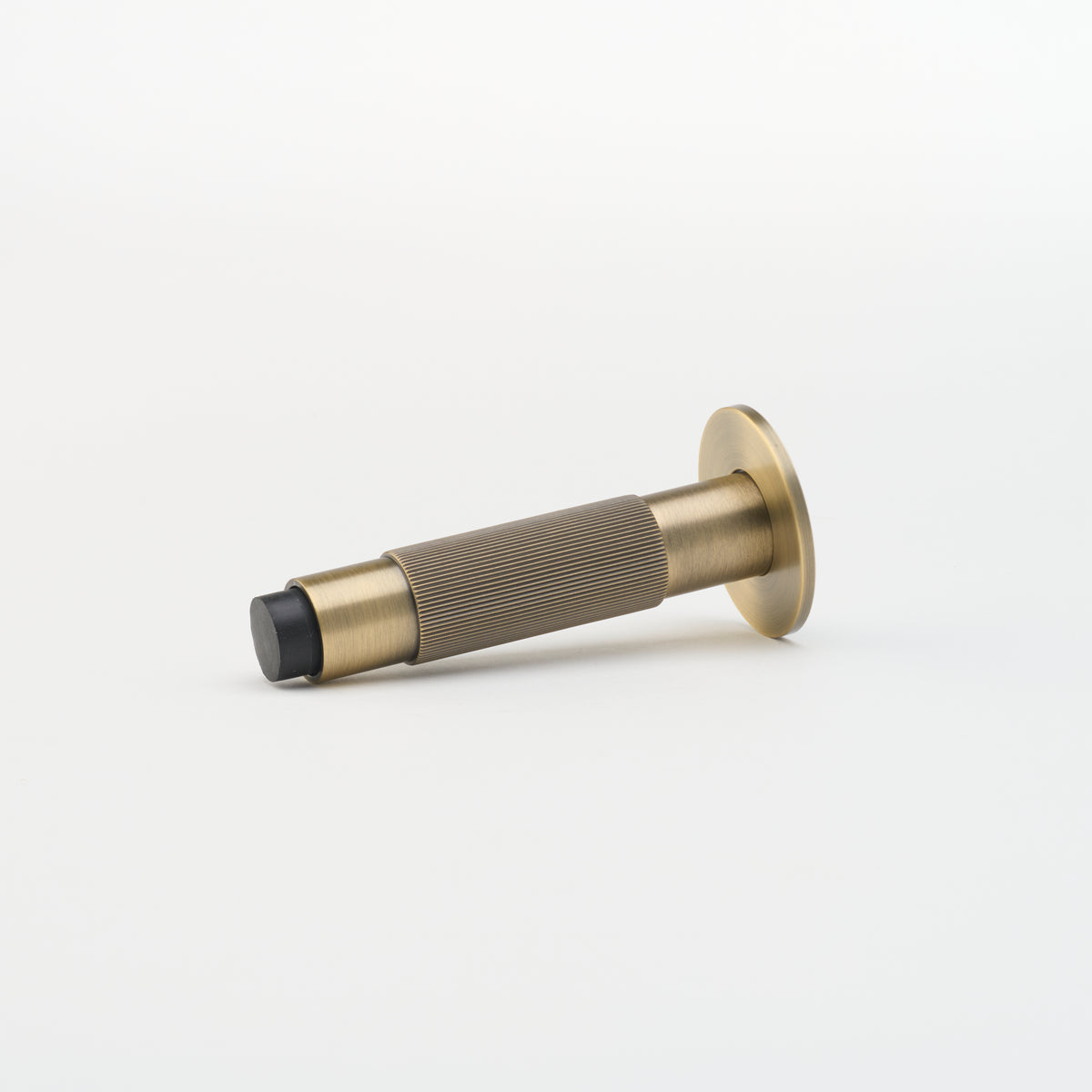 Lo & Co Linear Doorstop from Lo & Co Interiors, architectural hardware in brushed aluminum finish, mounted on a door.
