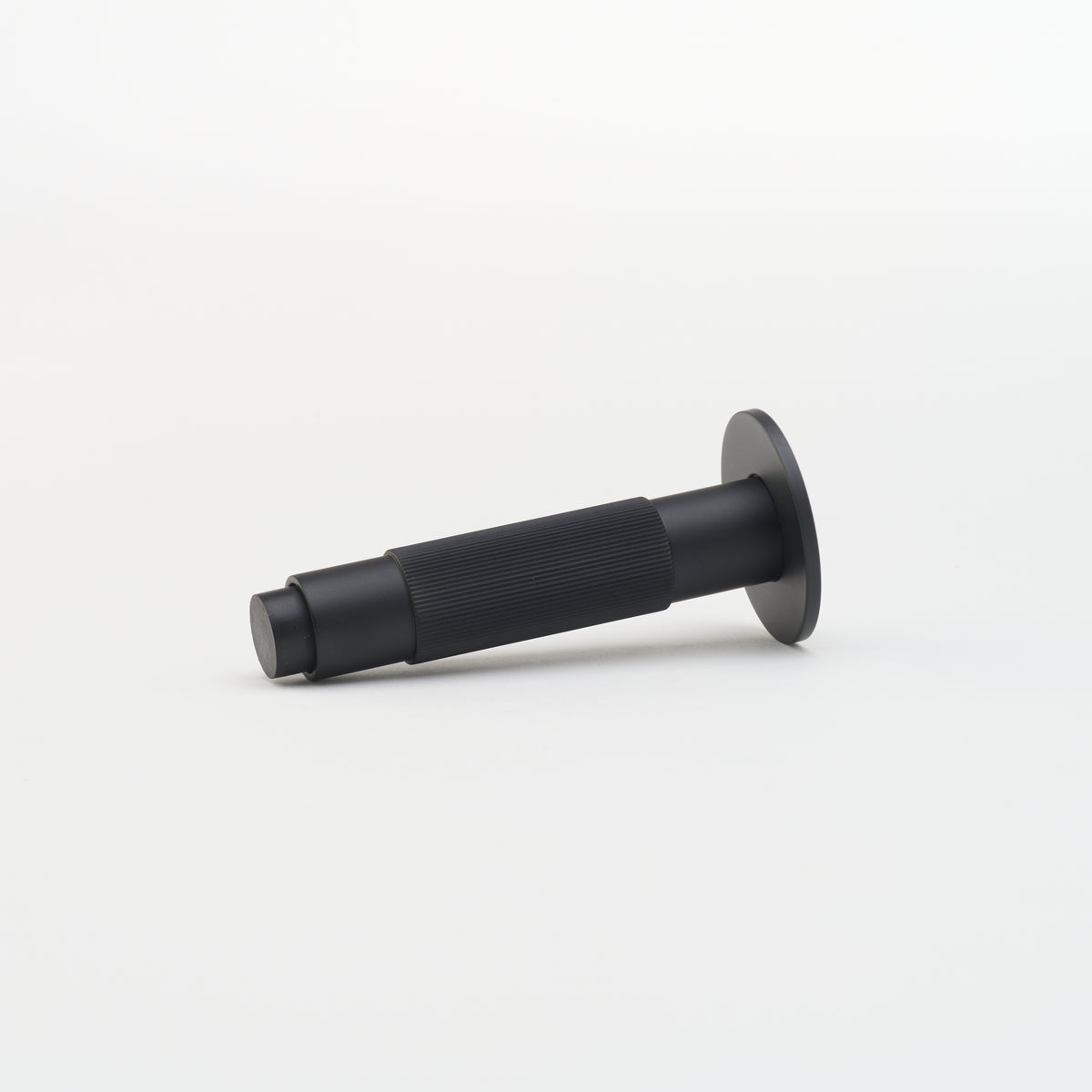 Lo & Co Linear Doorstop mounted on door in architectural hardware setting, showcasing sleek design and durable construction.