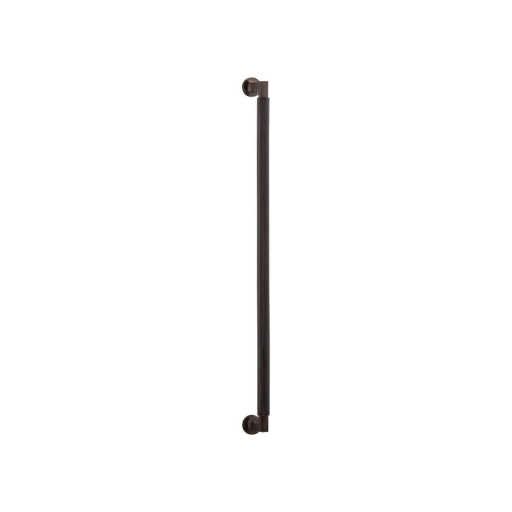 Iver Brunswick single pull handle in polished metal finish, mounted on a door for easy gripping and opening.