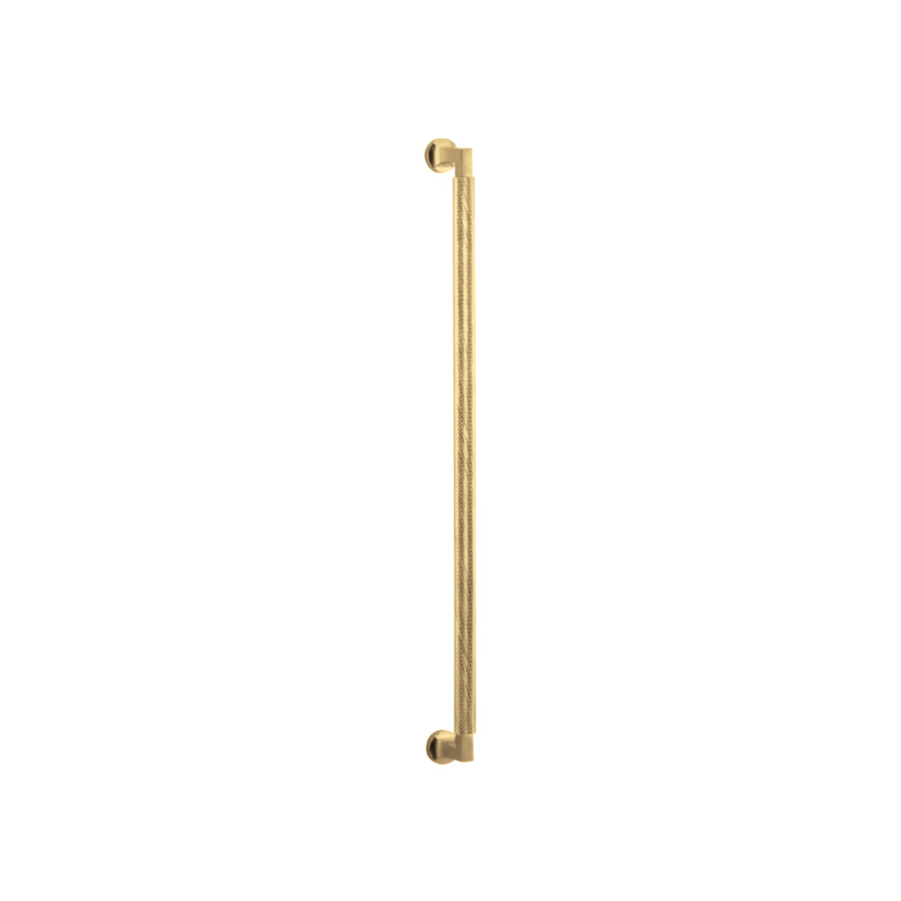 Iver Brunswick single pull handle, sleek brass door handle with modern design, mounted on a wooden door.