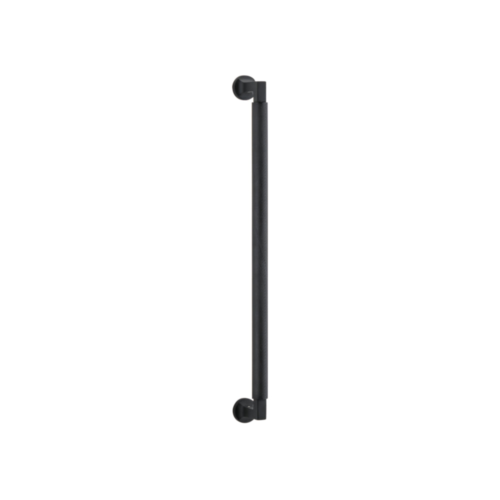 Iver Brunswick single pull handle in polished metal, mounted on a door for easy gripping and opening.